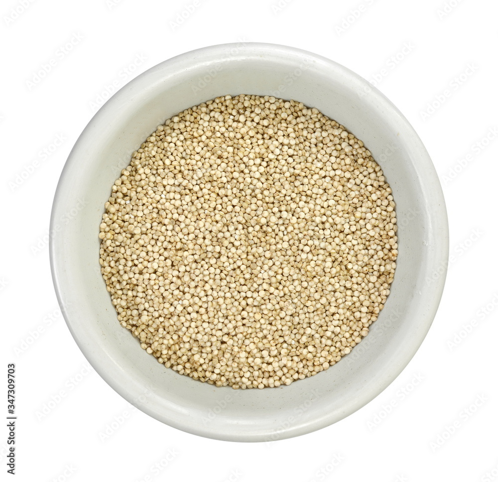 Organic Quinoa (Chenopodium quinoa) seeds in a white bowl isolated on white background. Macro close up. Top view. quinoa seeds isolated on white background. Organic Quinoa (Chenopodium quinoa) seeds in a white bowl isolated on white background. Macro close up. Top view. quinoa seeds isolated on white background.