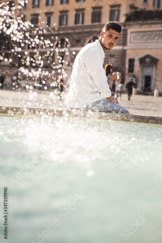 Nice boy posing in Rome during a sunny day untile the sunset photo