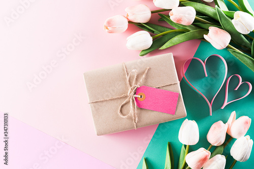 Happy Mother's Day, Women's Day or Valentine's Day greeting concept. Pastel Colours Background with tulip flowers and gift box ,flat lay patterns.