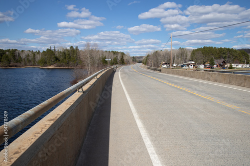 A northern Ontario highway pass over a lake on a bright spring day © kburgess