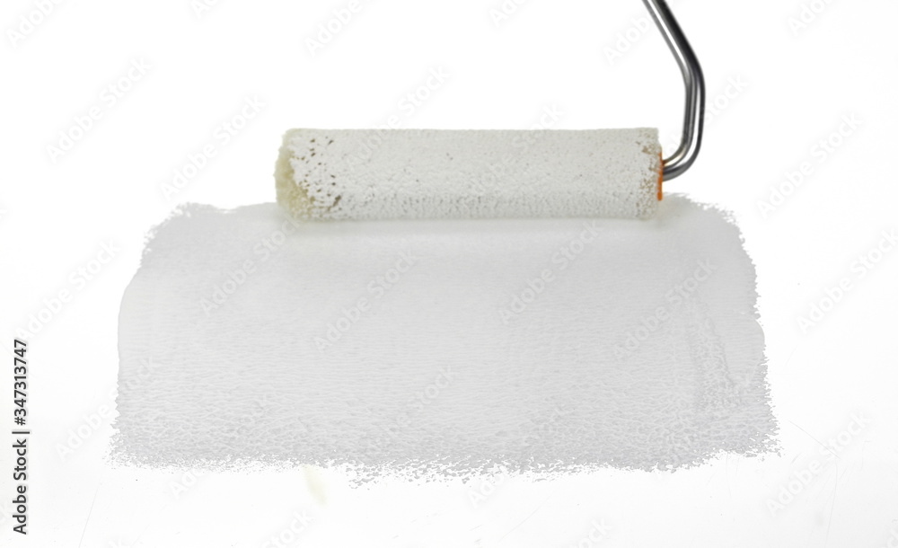 Obraz premium Painting a rough wall with roller. Paint roller leaving stroke of white color over a rustic background. usable for text and messages.