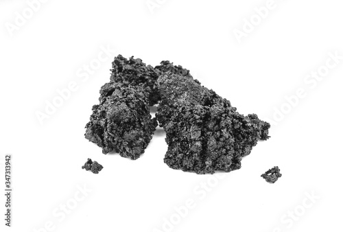 Piece of fresh asphalt isolated on white background. Pile of black raw asphalt.