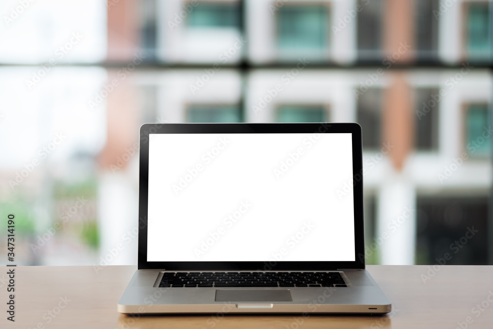 laptop showing blank screen on work table front view at with glass wall as background. laptop showing blank screen on work table front view at with glass wall as background.