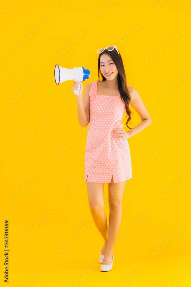 Portrait beautiful young asian woman speak loud with megaphone Portrait beautiful young asian woman speak loud with megaphone