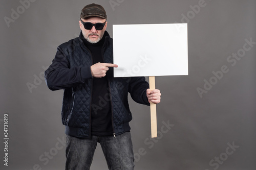 Adult man holds a banner. H...