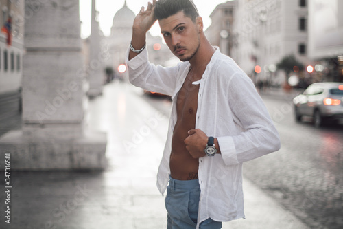 Nice boy posing in Rome during a sunny day untile the sunset photo