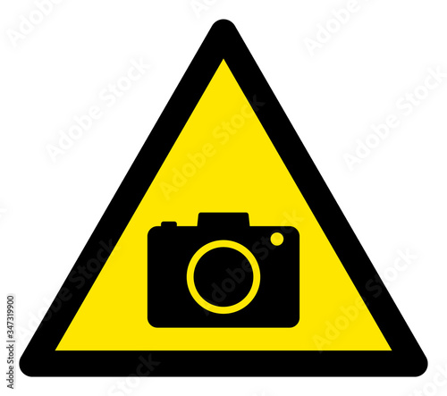 Vector photo camera flat warning sign. Triangle icon uses black and yellow colors. Symbol style is a flat photo camera attention sign on a white background. Icons designed for caution signals,