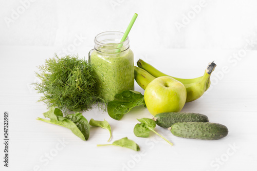 Mixed green smoothie with ingredients
