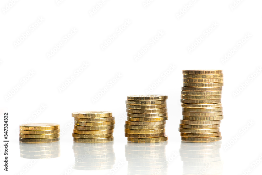 Columns of stacked coins showing growing graph. Invesment and savings concept Columns of stacked coins showing growing graph. Invesment and savings concept
