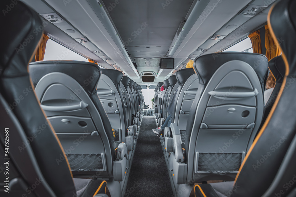 Interior of a bus with empty seats Interior of a bus with empty seats