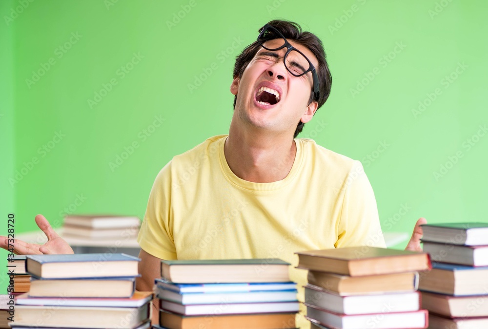 Student with too many books to read before exam Student with too many books to read before exam