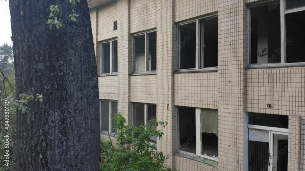 Abandoned building exterior with broken windows. Aerial side view. Abandoned building exterior with broken windows. Aerial side view.