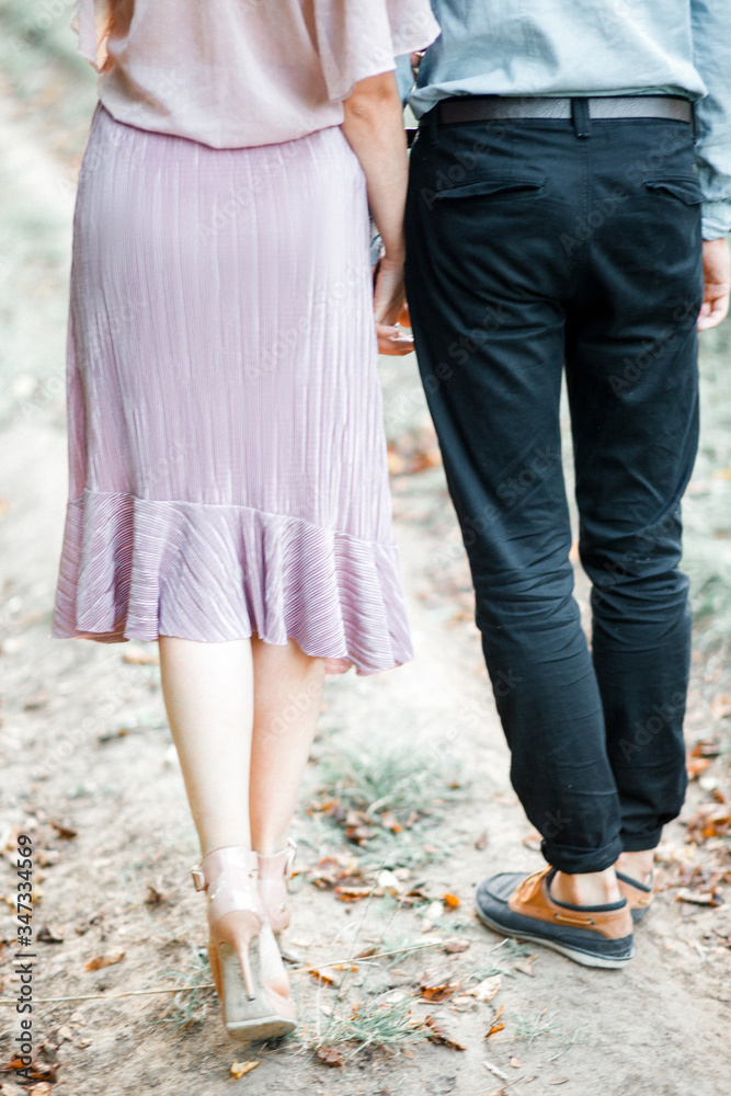 Couple is walking along a path in the forest. Date. Love. Relationship. 