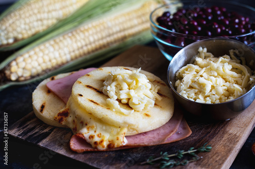 Cheese arepa with ham and grains like beans. Typical food of Colombia and Venezuela photo