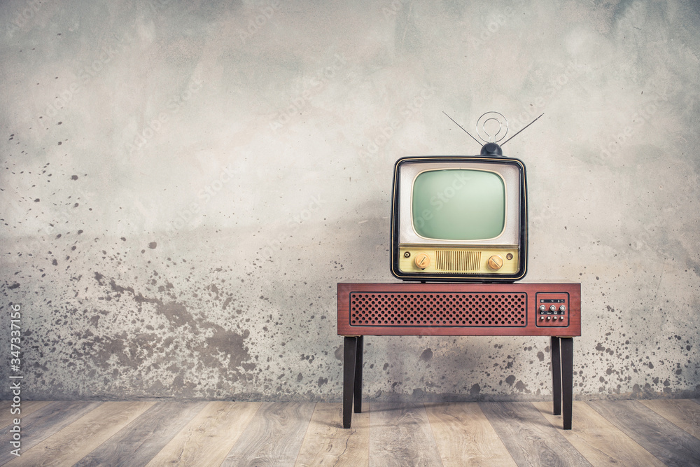 Old retro classic analog CRT TV set receiver and aged wooden television