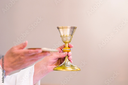 chalice with wine, blood of christ, and pyx with bread, body of christ, ready for the communion of the faithful
