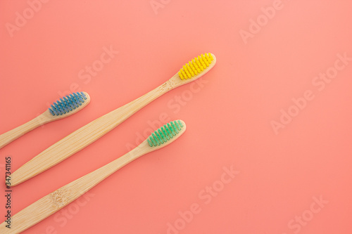 wooden toothbrush on pink background