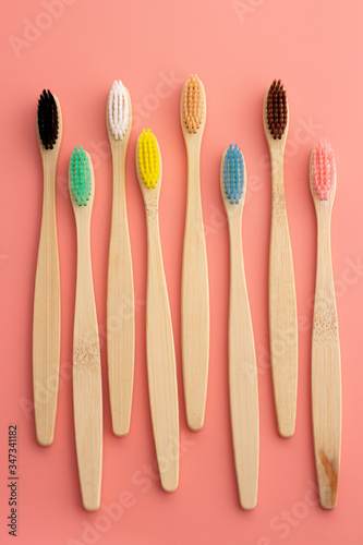 wooden toothbrush on pink background