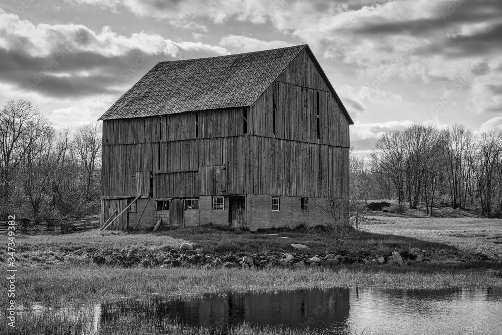 Rural black and white landscapes featuring old barns and farmland with sky and sunset. Ontario Canada Rural black and white landscapes featuring old barns and farmland with sky and sunset. Ontario Canada