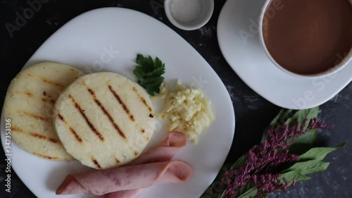 HANDS picking arepas in the middle of food, served at the table. Colombian and Venezuelan food