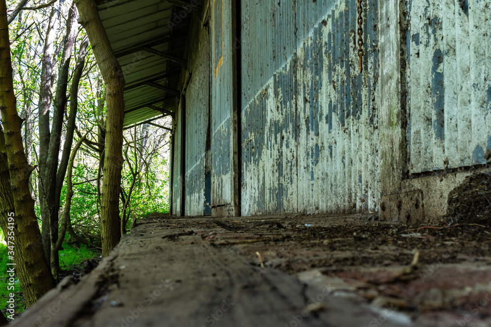 Old metal sheet train station shed. Abandoned warehouse