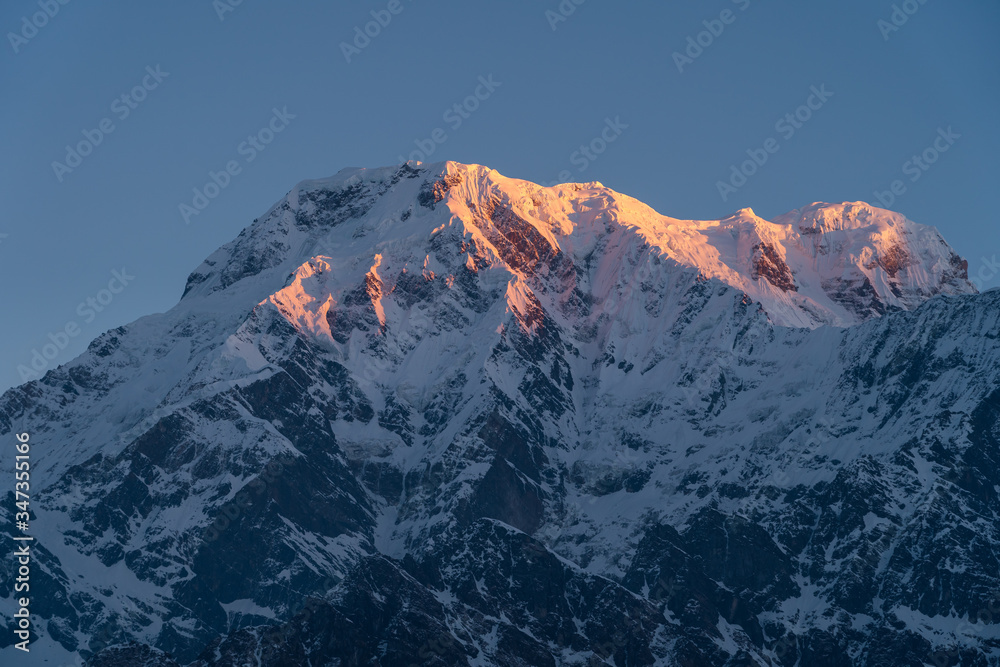 Red morning sunrise light over Annapurna south mountain peak view from Mardi Himal trekking route, Himalaya mountains range in Nepal