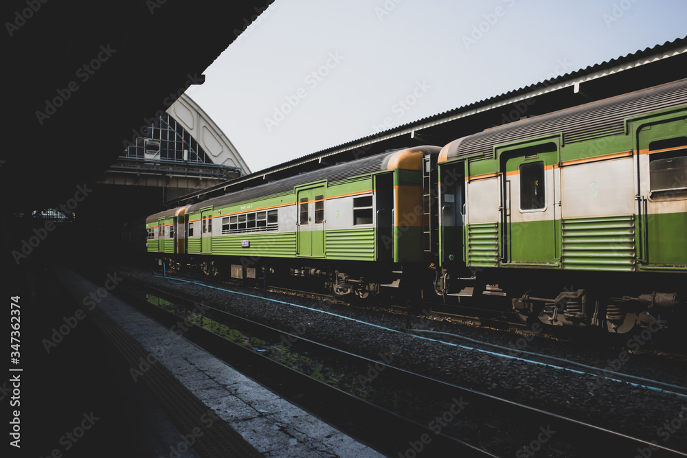 Fototapeta premium vintage train. diesel locomotive train stop at public station. old railway station with trains and railway. vintage transportation