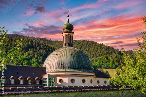 The Benedictine monastery St. Trudpert (Kloster Sankt Trudpert) in the Black Forest in Muenstertal at sunset in front of a colourful sky