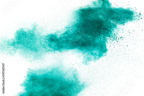 Fototapeta Naklejka Na Ścianę i Meble -  Abstract splash of green colored powder on white background.Green powder explosion.