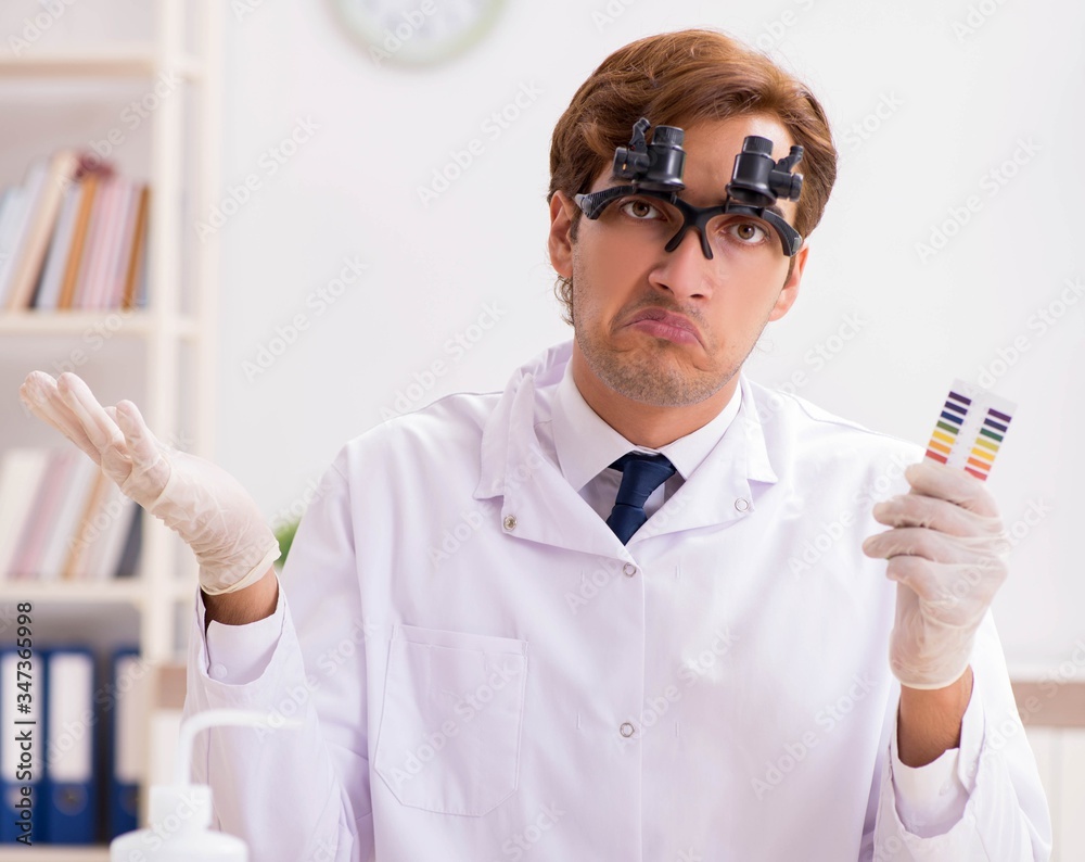 Chemist in the lab checking with ph strips Chemist in the lab checking with ph strips