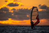 girl riding windsurf on the background of an incredible sunset. Mauritius Island