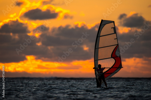 girl riding windsurf on the background of an incredible sunset. Mauritius Island