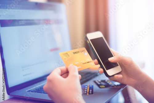 Woman hand is holding credit card, shopping online