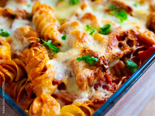 Pasta casserole with barbecue chicken breast, cheese and vegetables
