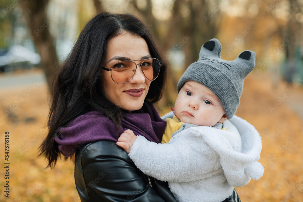young beautiful Caucasian girl mom holding her little boy baby son young beautiful Caucasian girl mom holding her little boy baby son