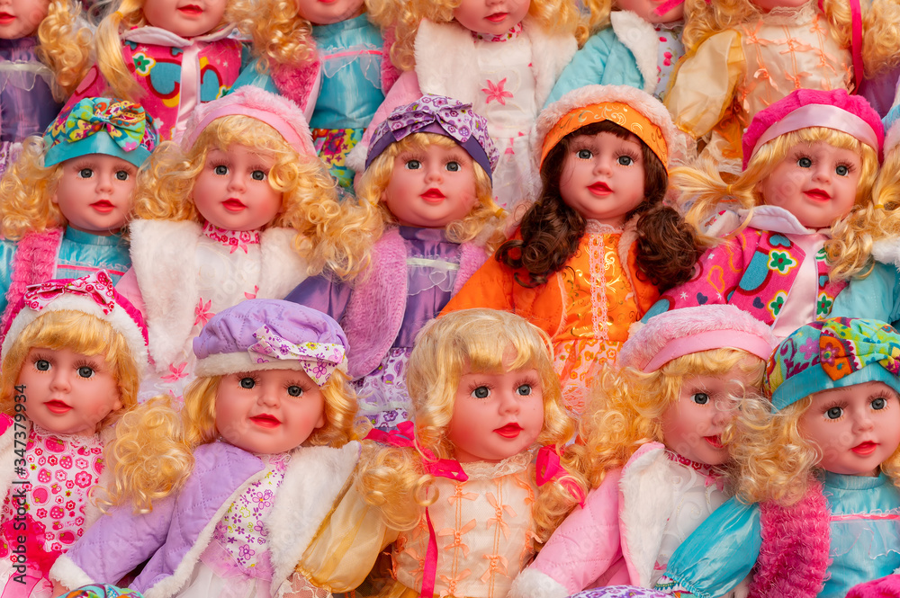 Fototapeta premium Colourful tiny girl baby dolls for sale at retail shop at Christmas market, New Market area, Kolkata, West Bengal, India.