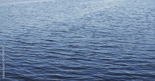 Slow motion shot of water ripples over a river or a lake.