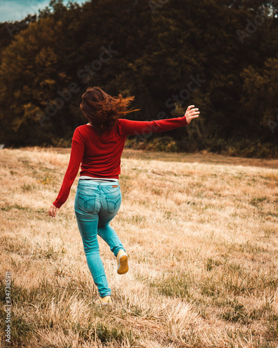 Young woman running in a field