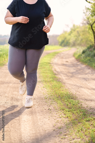 Cropped portrait of overweight runner go jogging outdoors. Weight losing, sports, healthy lifestyle