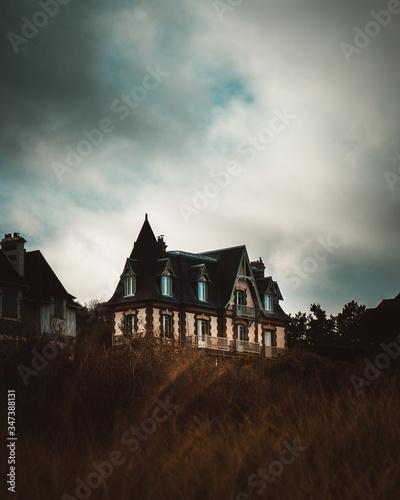 old house in Normandy under a cloudy sky