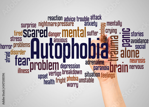 Autophobia fear of being alone word cloud and hand with marker concept photo