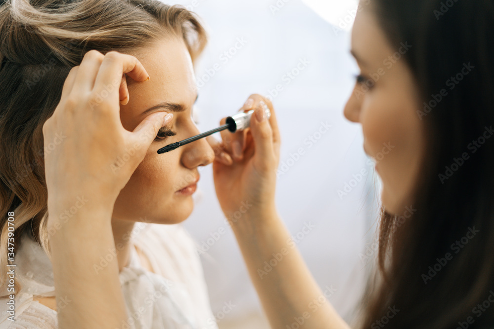 Close-up of professional make-up artist putting shadows on eyelids in beauty salon. Concept of beauty, fashion and stylish makeup. Close-up of professional make-up artist putting shadows on eyelids in beauty salon. Concept of beauty, fashion and stylish makeup.