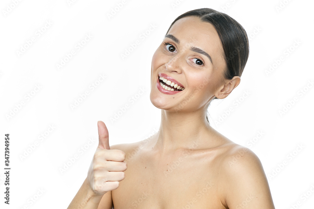 Close up portrait of a girl with big eyes and clear skin on a white background with a beautiful wide smile and white teeth Close up portrait of a girl with big eyes and clear skin on a white background with a beautiful wide smile and white teeth