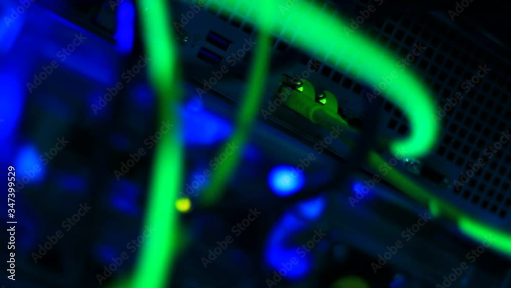 Working server in a server room. Details of cables, UTP, Rj45 connections, out of focus, vivid colors, artistic presentation. Working server in a server room. Details of cables, UTP, Rj45 connections, out of focus, vivid colors, artistic presentation.