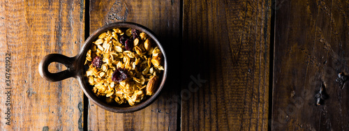 Granola in a clay pots with a beautiful wooden rustic background. Healthy concept. Vegan Concept. Copy space. Top view