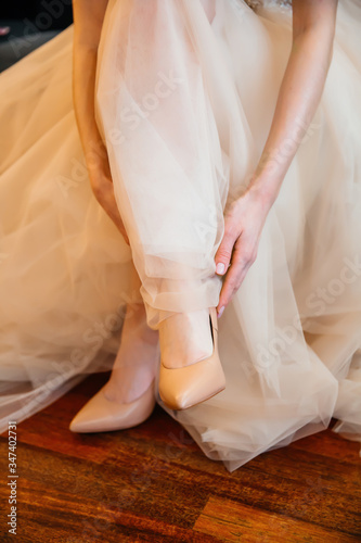bride straightens her shoes