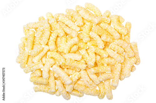 A heap of corn snacks. Sweet sticks of puffcorn top view
