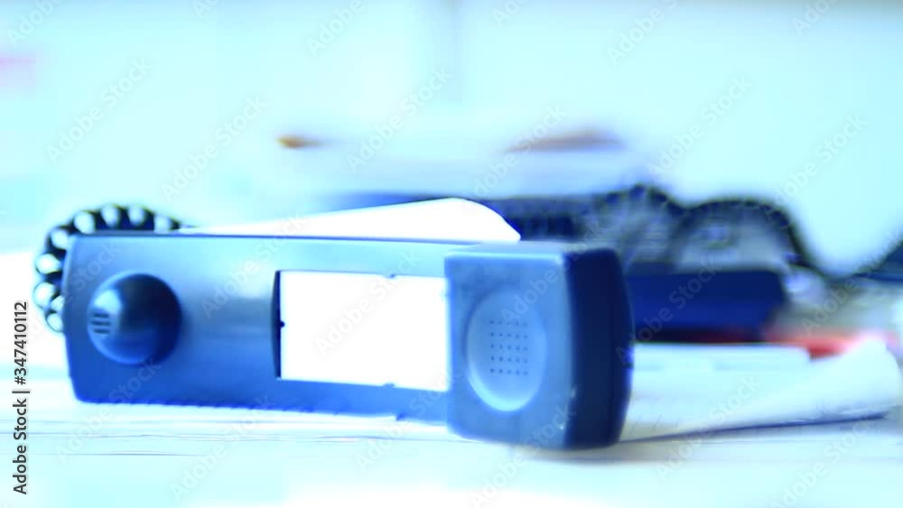Very angry, unpredictable male, person, operating with telephone, waiting for a call, ending it. Office. Close up. Bright light. Very angry, unpredictable male, person, operating with telephone, waiting for a call, ending it. Office. Close up. Bright light.