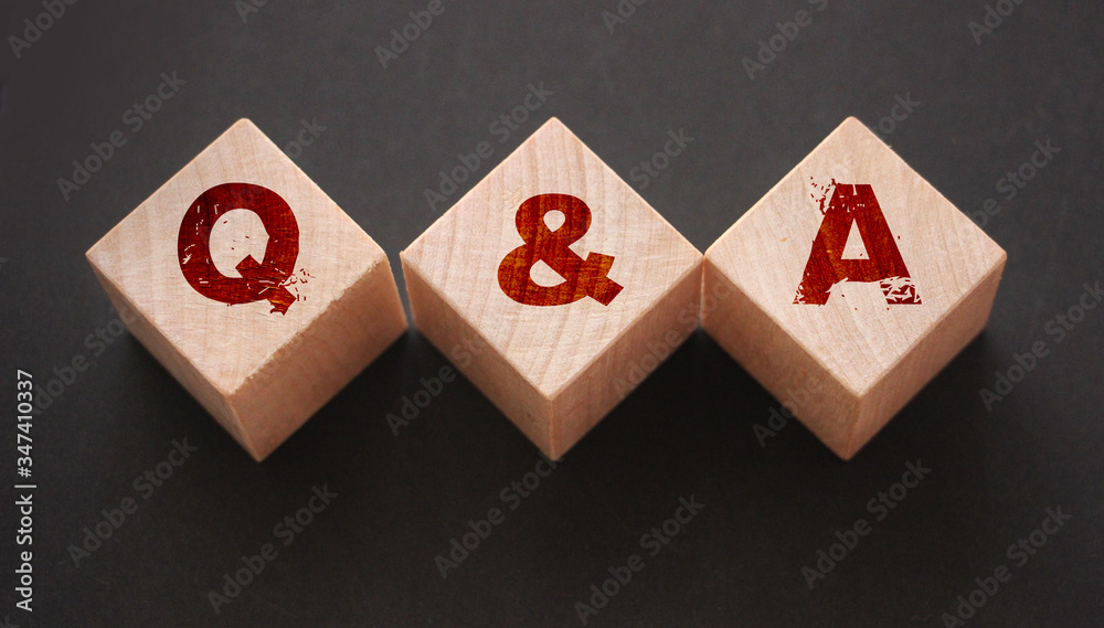 Q and A on wooden blocks Close-up Shot . Question and answers support center business concept