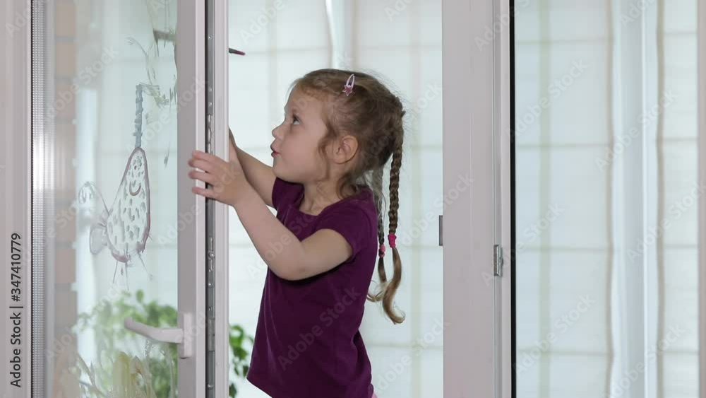 Self-isolation at home. Child quarantined girl paints a rainbow on a glass window. Art Therapy and Distance Learning Self-isolation at home. Child quarantined girl paints a rainbow on a glass window. Art Therapy and Distance Learning